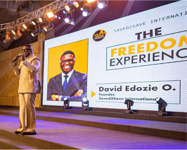 Speaker on stage before The Freedom Experience LED backdrop