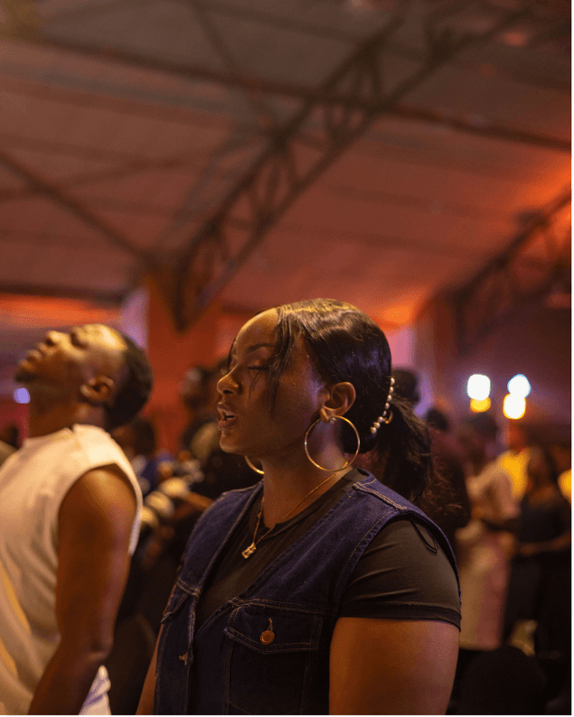 Woman in quiet worship amid the Freedom Experience gathering