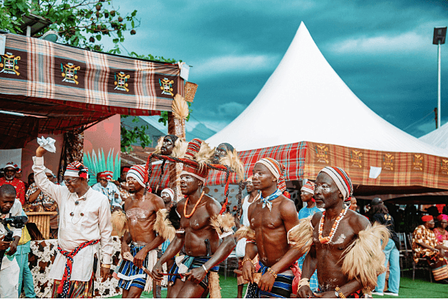 Shirtless procession with coral beads and chalk markings