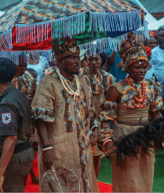 Couple under a fringed ceremonial umbrella in leopard accents