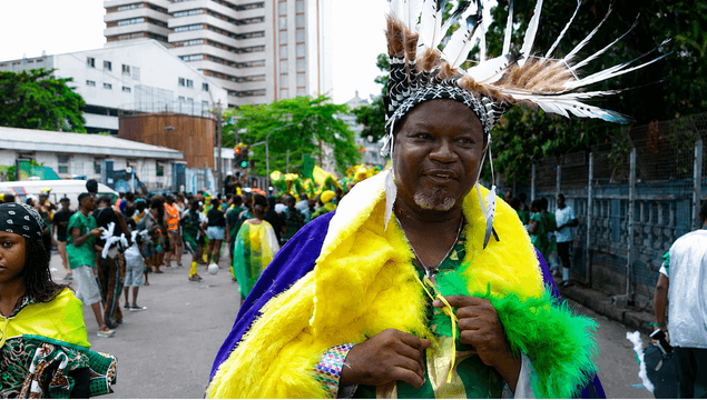 Carnival performer in yellow and purple feathered costume