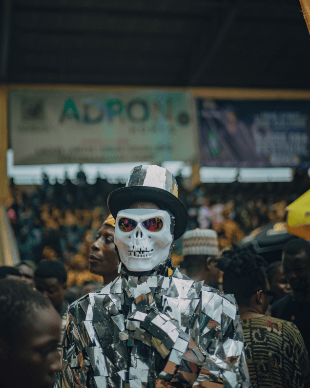Festival performer in a mirrored skull-mask costume