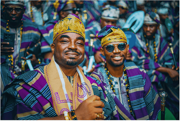 Two men in purple and gold agbada at Ojude Oba