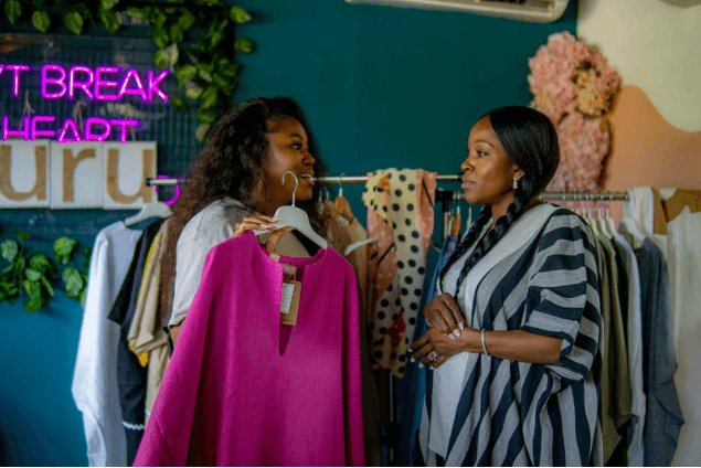 Presenting a magenta garment beside the RURU neon wall